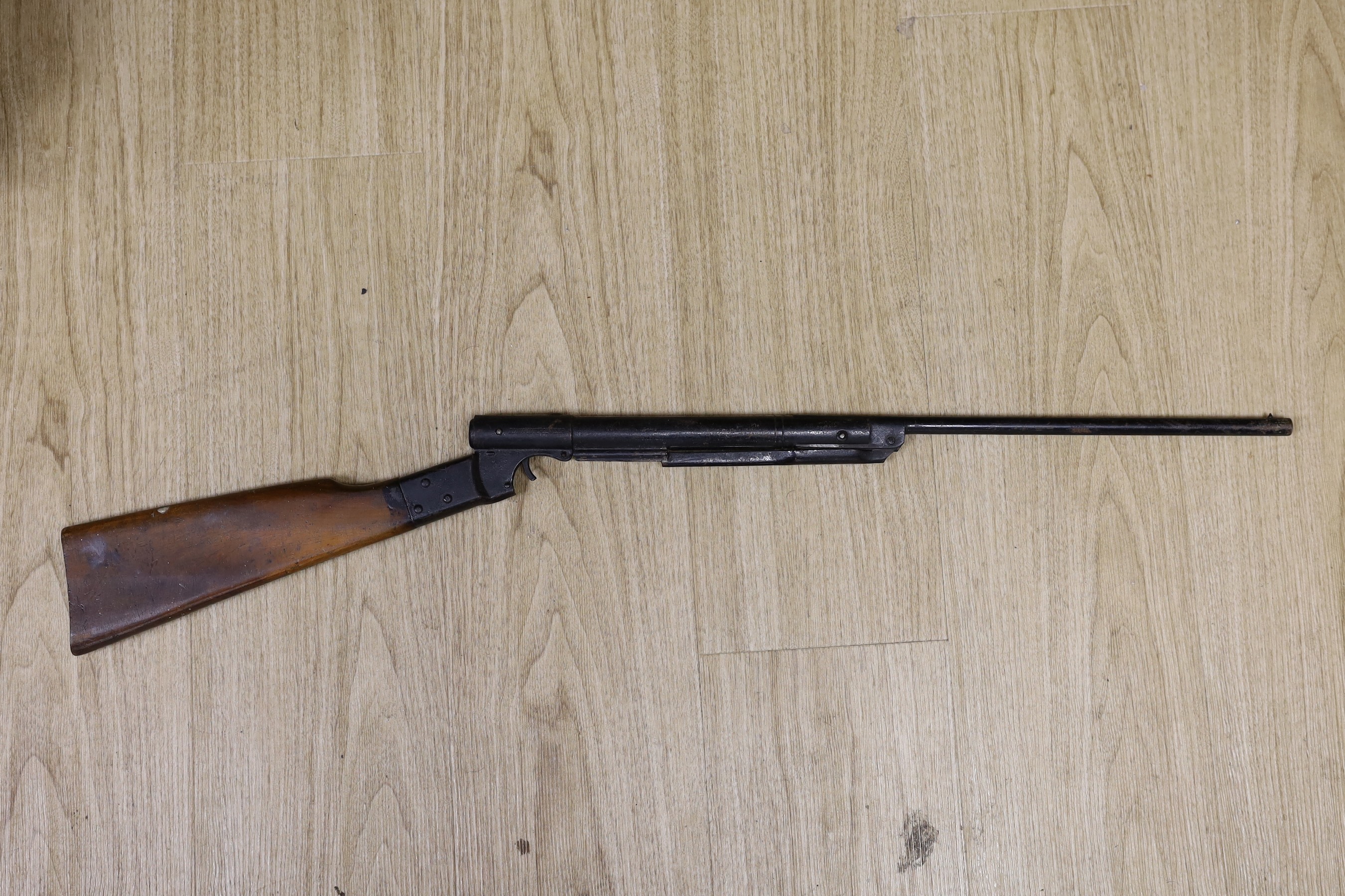Two Webley air pistols, another, an air rifle and a part rifle